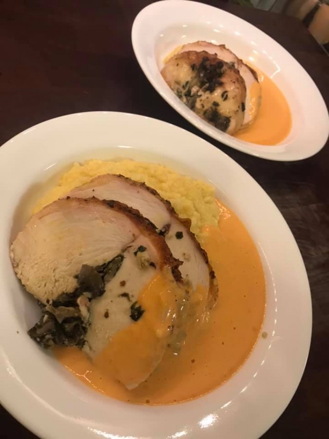 Chicken Ballentine served over cheesy grits topped with roasted red pepper cream sauce.jpg